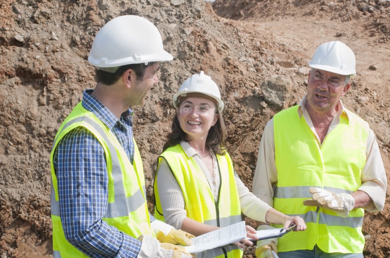 three engineers in construction site