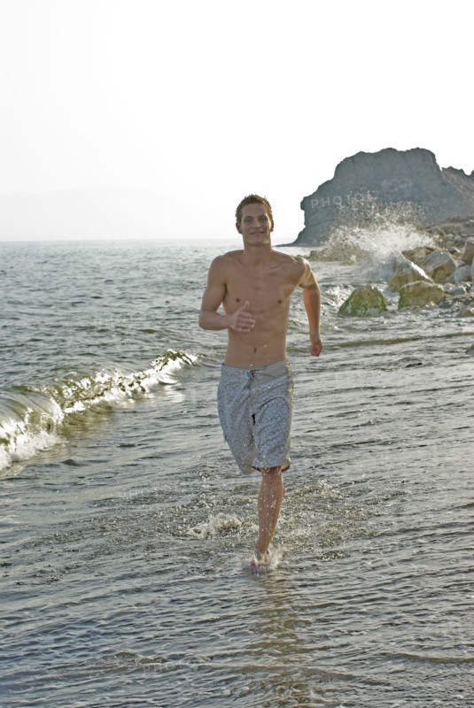 young man running in surf