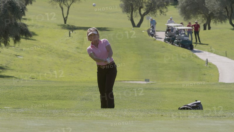 Caucasian woman playing golf on course