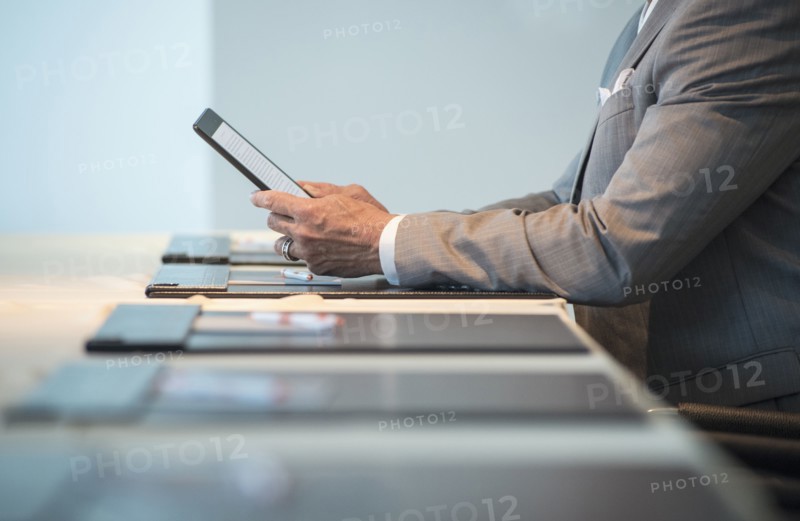 Caucasian businessman using digital tablet at conference table