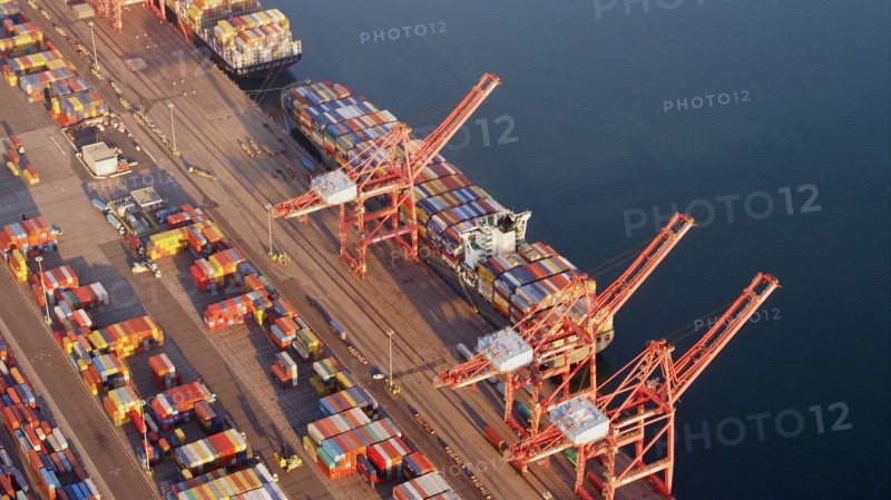 Aerial view of containers and cranes in industrial shipyard