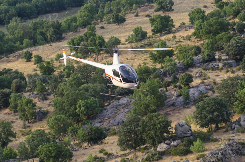 Aerial view of helicopter flying over remote landscape