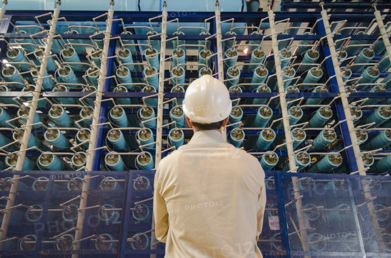 Hispanic technician examining power grid infrastructure