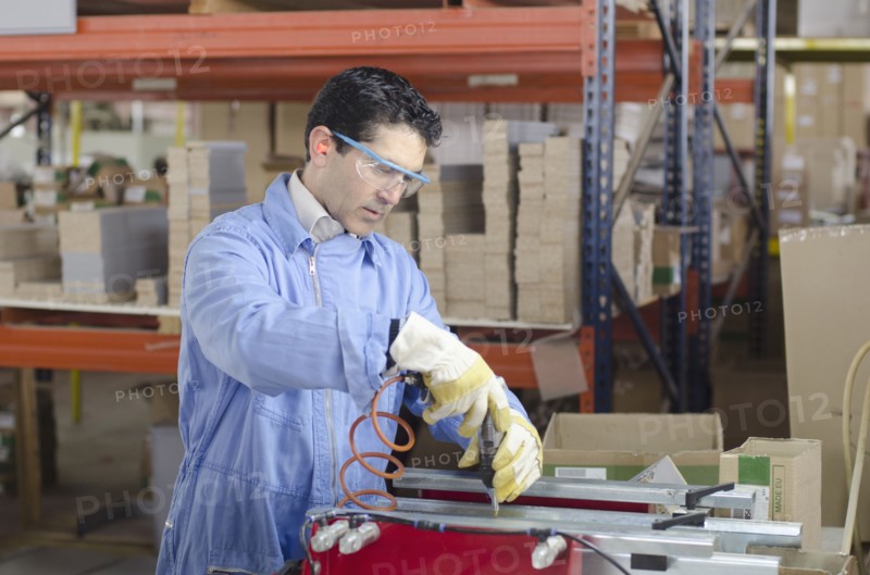 Hispanic technician working in factory