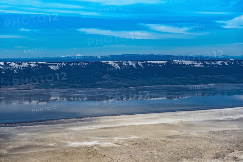 Aerial view of mountains reflecting in lake