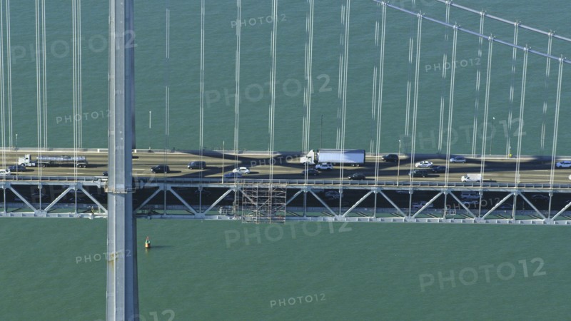 Aerial view of cars and trucks driving on bridge