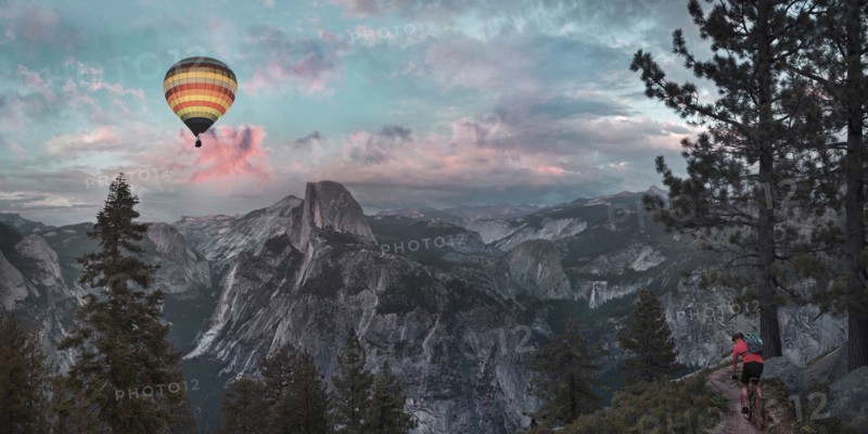 Hot air balloon floating over dramatic mountains