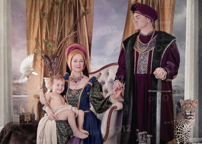 Medieval couple and child posing in living room
