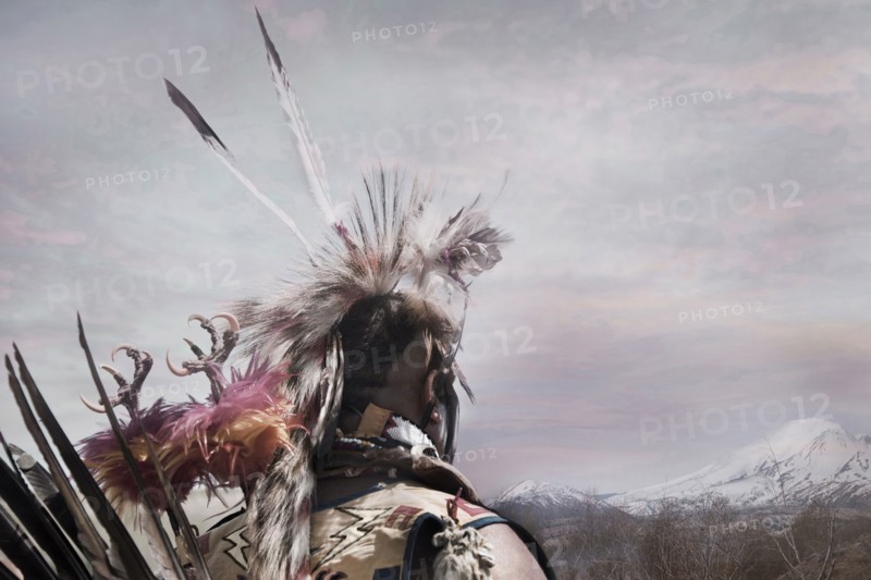 Hunter wearing traditional native headdress
