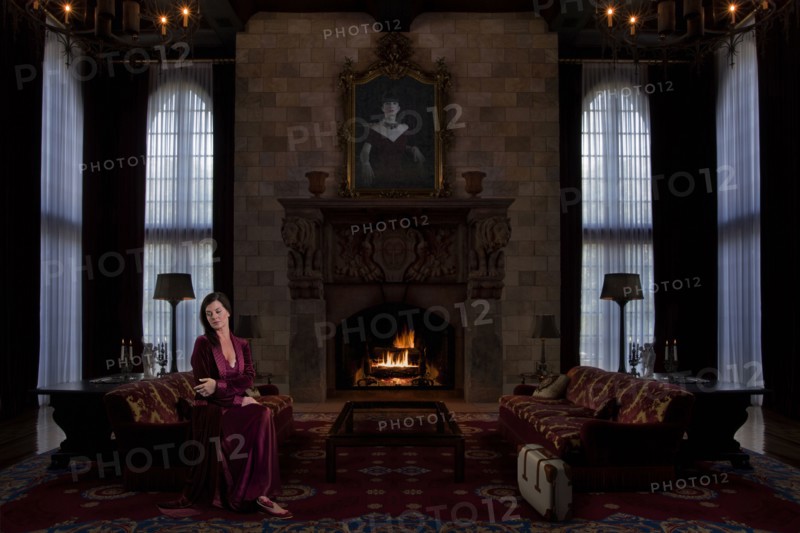 Caucasian woman sitting in ornate living room