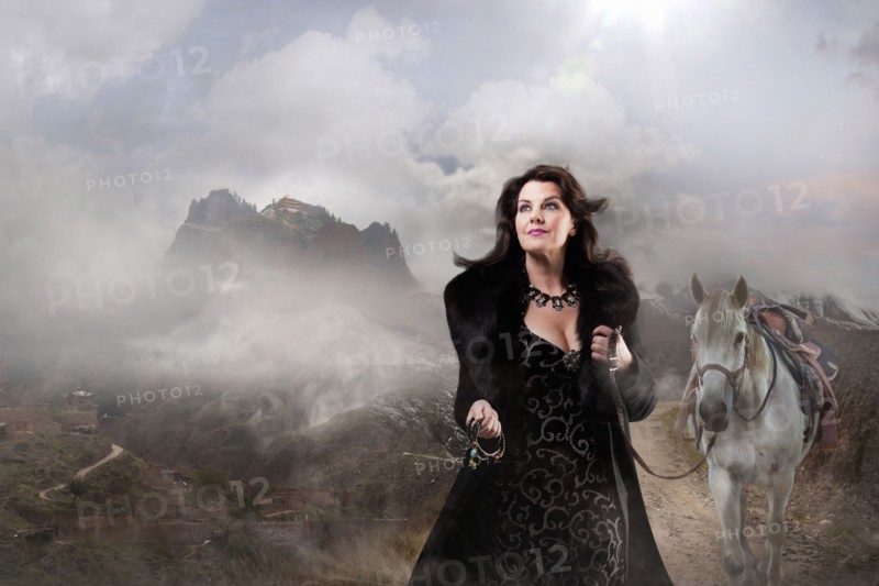 Caucasian woman walking horse in remote landscape