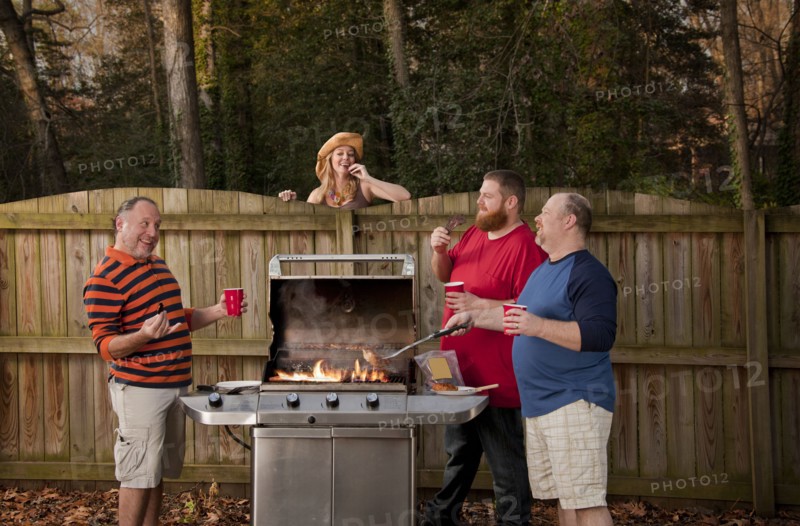 Woman watching neighbors barbecuing food