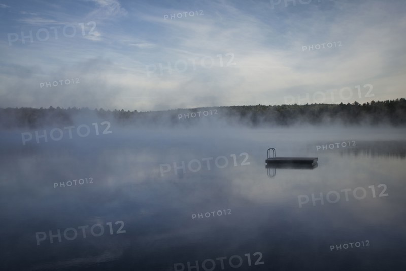 Dock floating on misty remote lake
