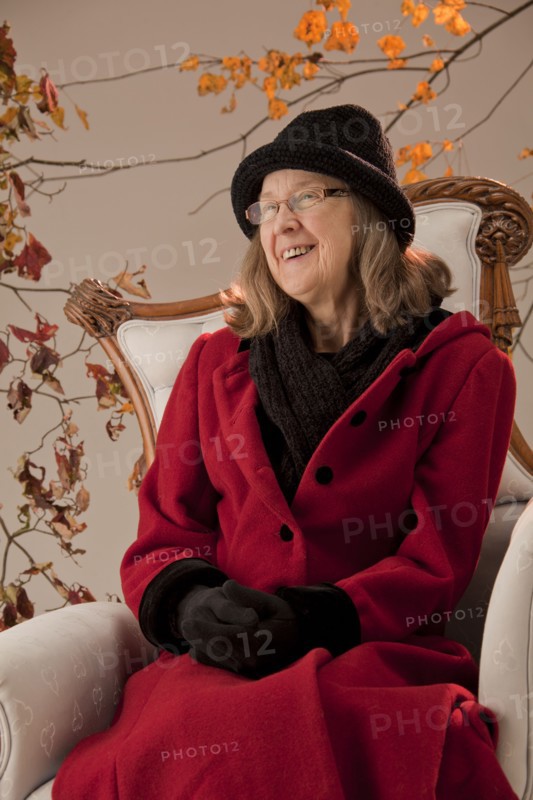 Caucasian woman sitting in armchair outdoors