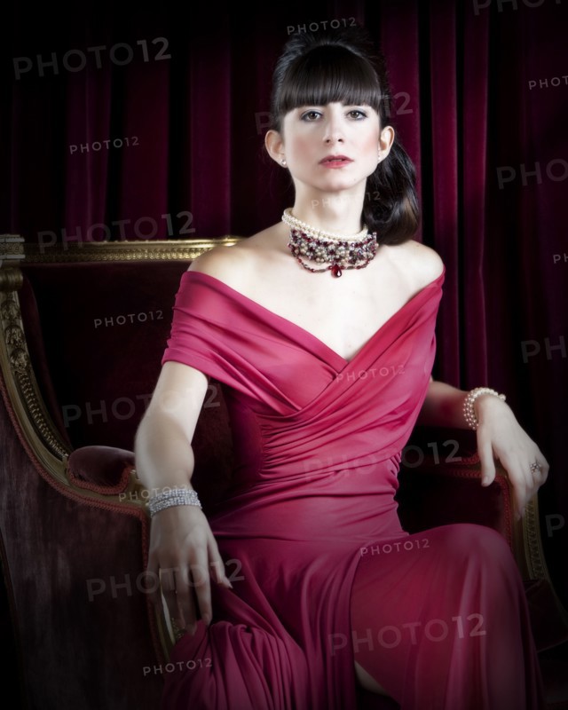 Caucasian woman wearing jewelry and red evening gown