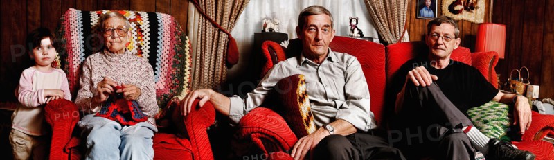 Portrait of older people with granddaughter in livingroom