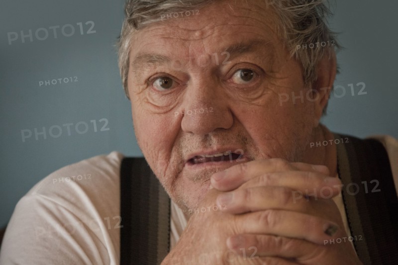 Surprised Caucasian man with hands clasped