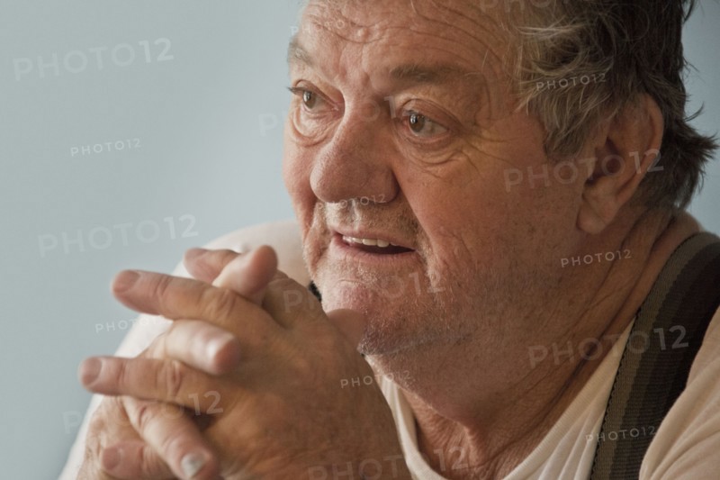 Surprised Caucasian man with hands clasped