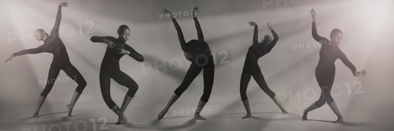 Multiple exposure of Mixed Race woman dancing