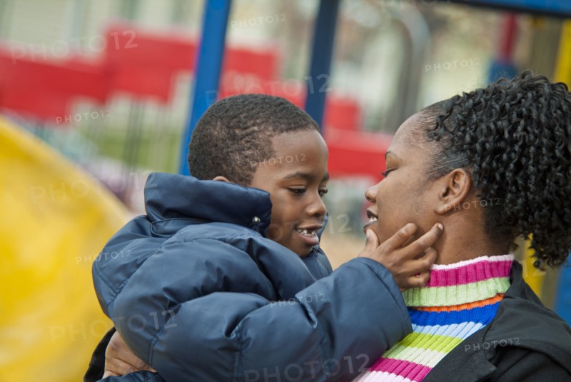 Smiling mother carrying son