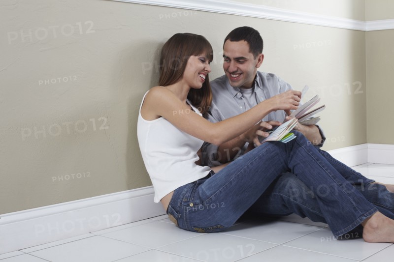 Hispanic husband and wife looking at color swatches