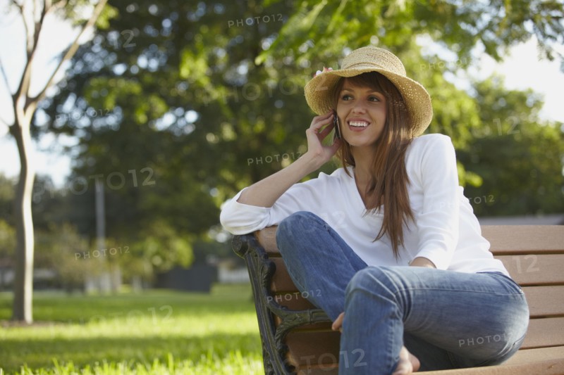 Mixed race woman talking on cell phone outdoors