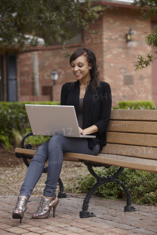 Mixed race woman typing on laptop