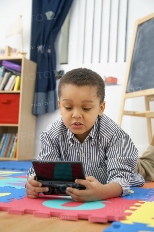 Mixed race boy playing video game