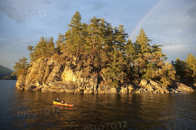 Hispanic woman kayaking on lake