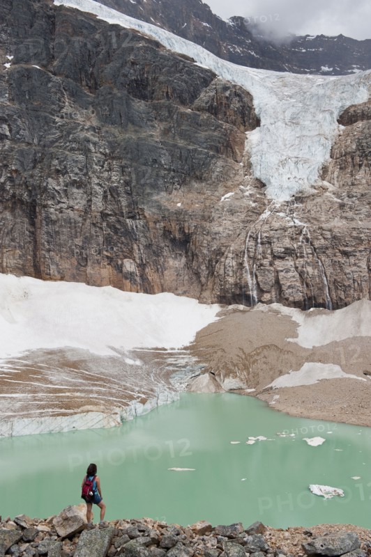 Hispanic woman hiking hear glacial lake