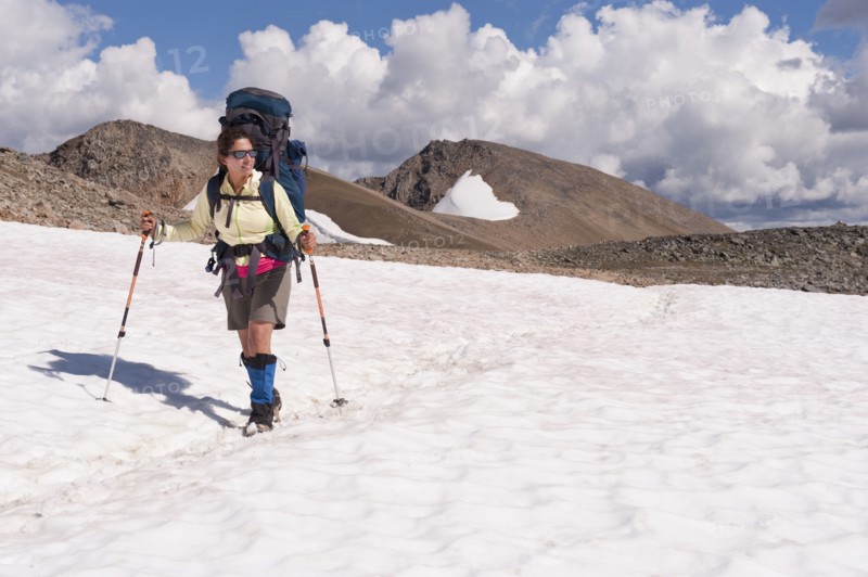 Hispanic woman hiking over snow