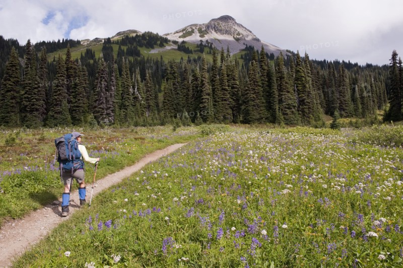 Hispanic woman hiking near mountain