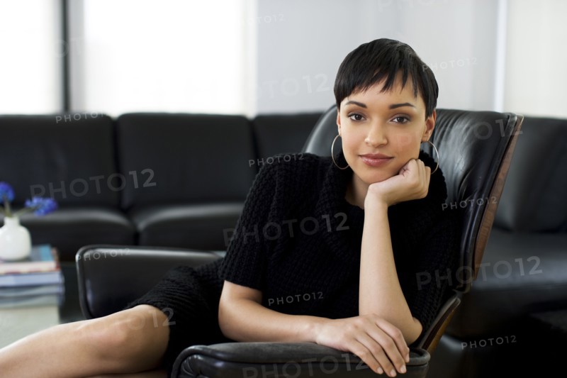Serious businesswoman sitting in chair