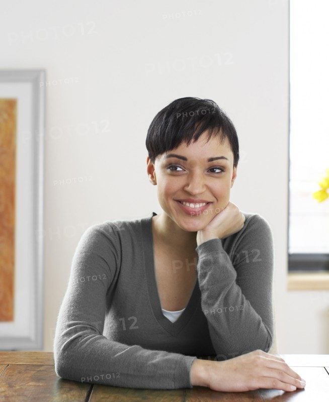 Smiling woman with hand on chin