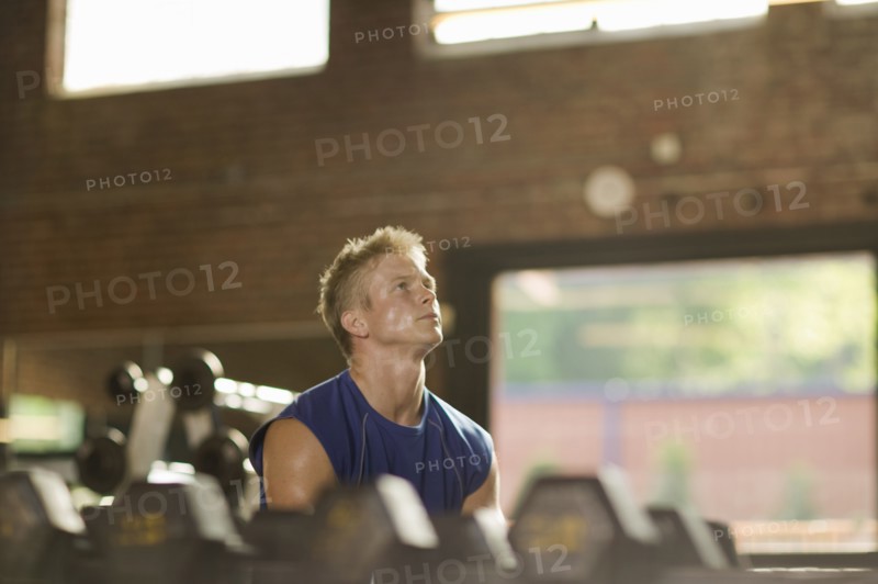 Man lifting weights in health club
