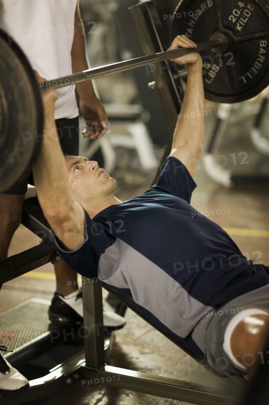 Man lifting weights in health club