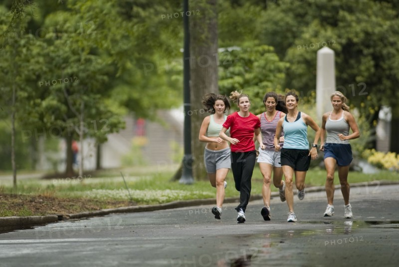 Runners jogging in park