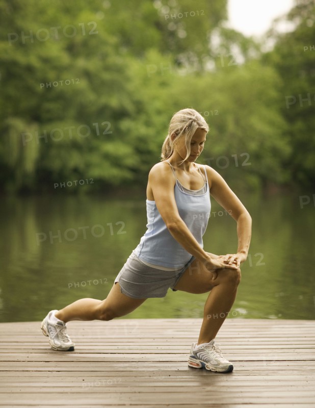 Woman stretching on pier