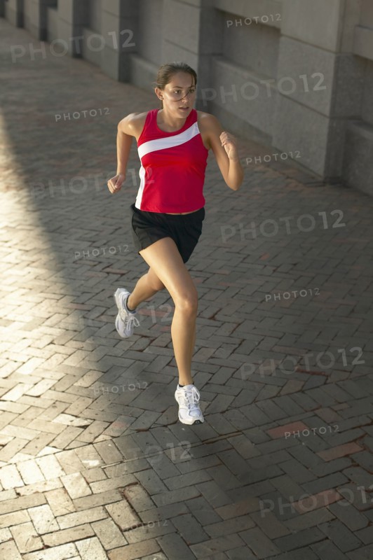 Woman jogging on sidewalk