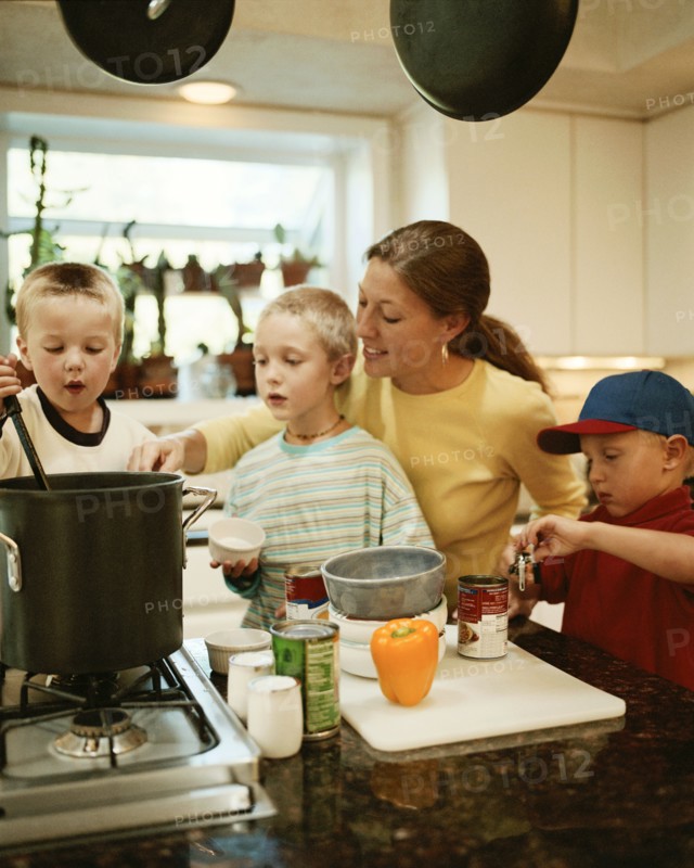 Caucasian mother and sons preparing food