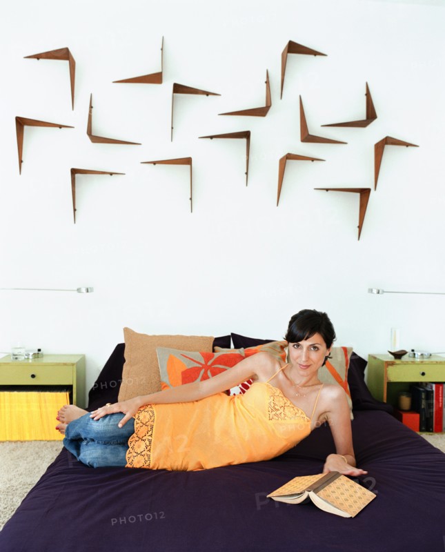 Woman reading book in bed