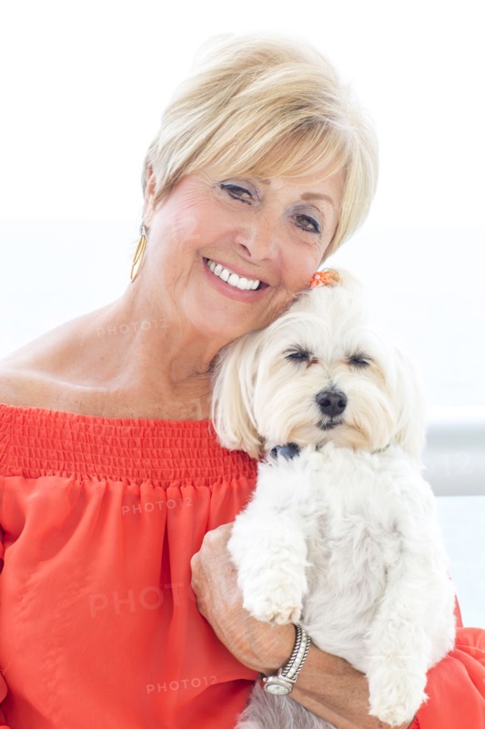 Older Caucasian woman hugging dog