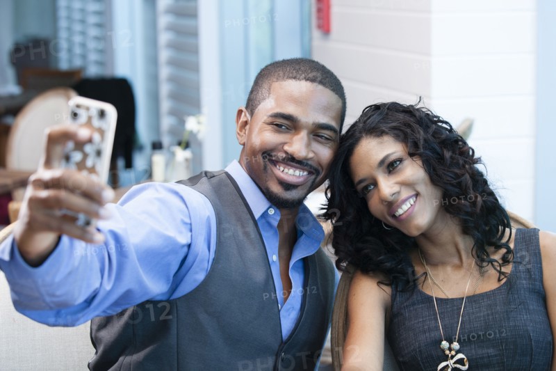 Business people taking selfie with cell phone in office
