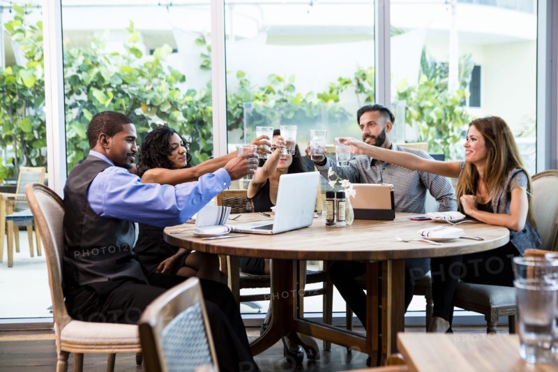 Business people toasting at lunch in cafe