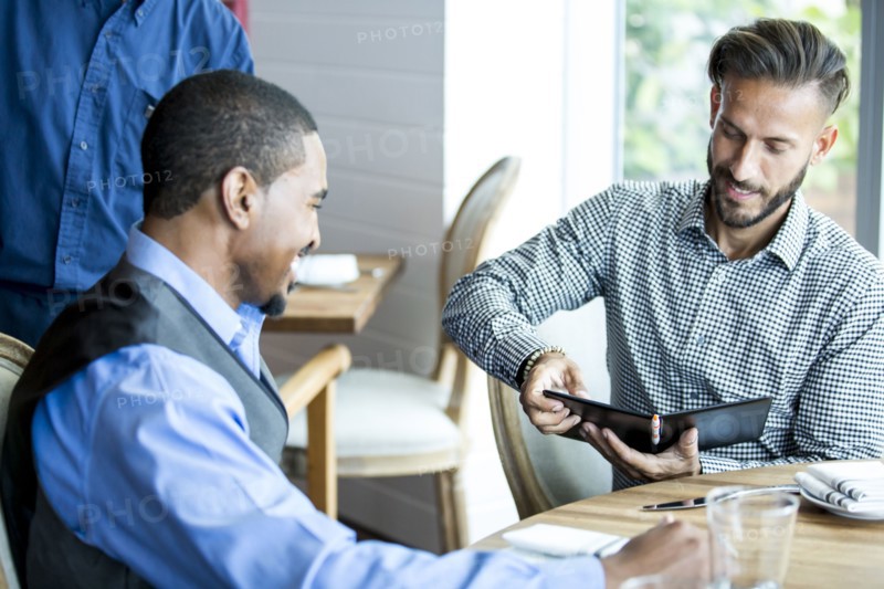 Businessman paying for lunch in cafe