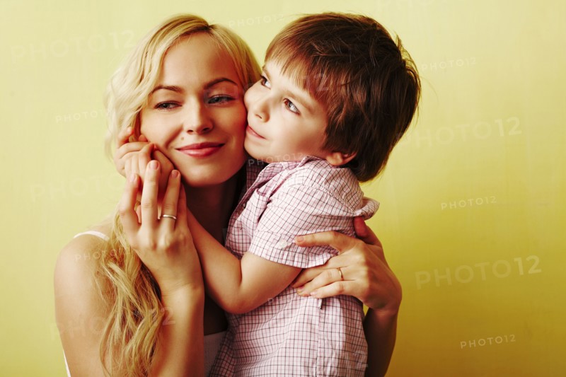 Smiling mother hugging son