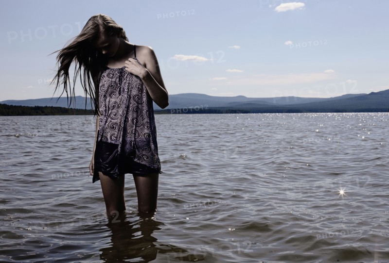 Woman wading in remote lake
