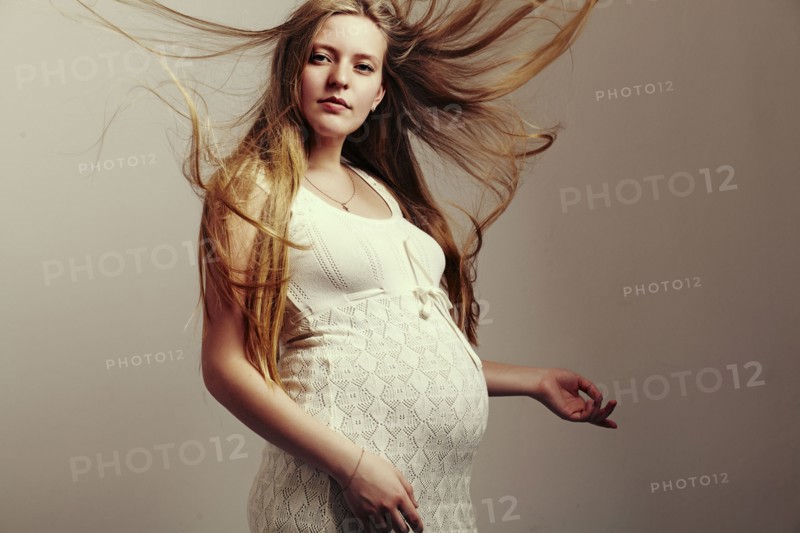 Pregnant woman with windblown hair