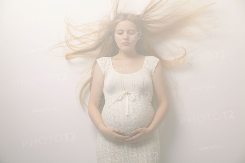 Pregnant woman with windblown hair