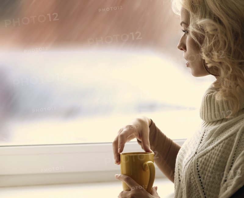 Caucasian woman looking out window